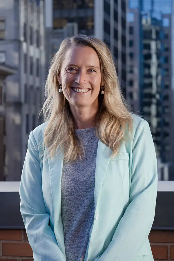 Team Portrait of Laura Dowling, leadership consultant at TCS, standing in front of a corporate building