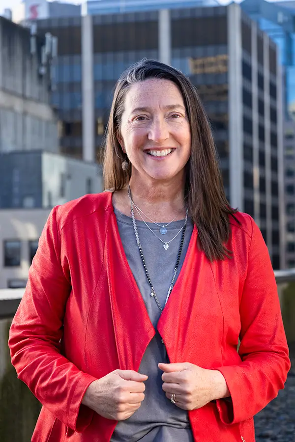 Team Portrait of Julie Foxcroft, leadership consultant at TCS, standing in front of a corporate building